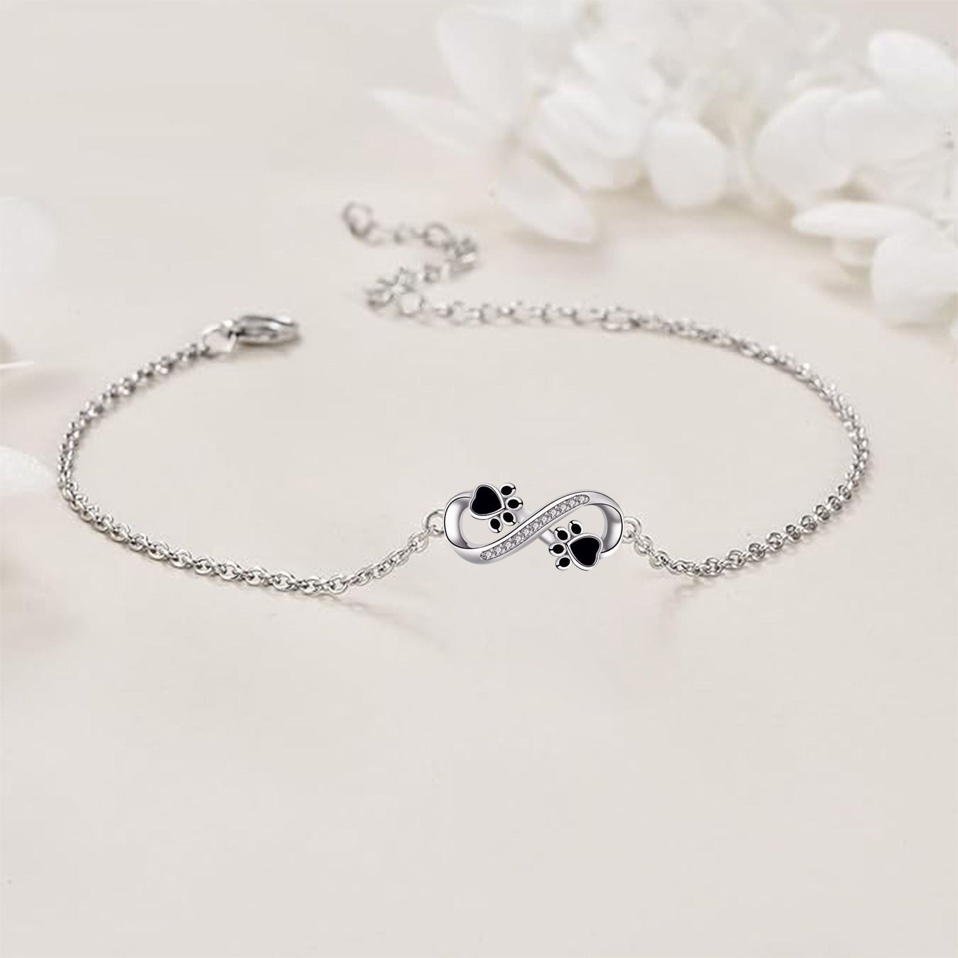 Armbånd med potepreg og uendelighetssymbol, med zirkonia